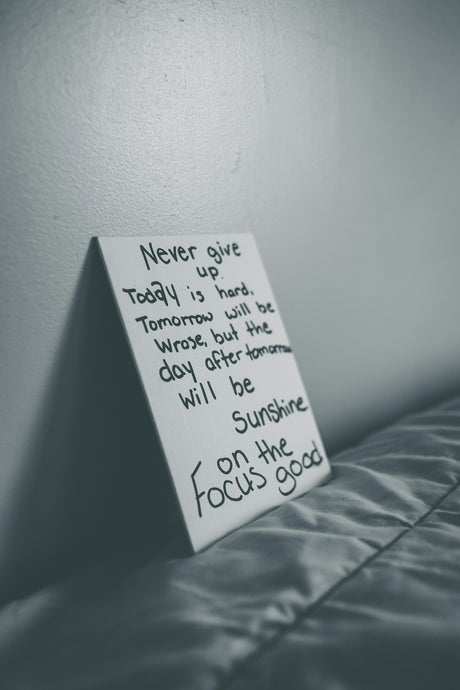 a note attached to a wall on a bed