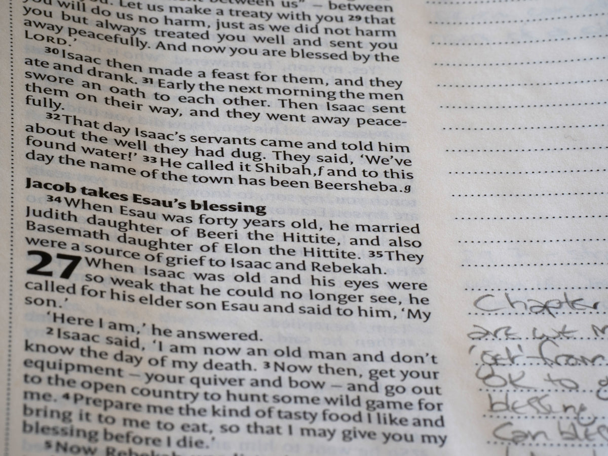 Close-up of an open bible with handwritten notes.