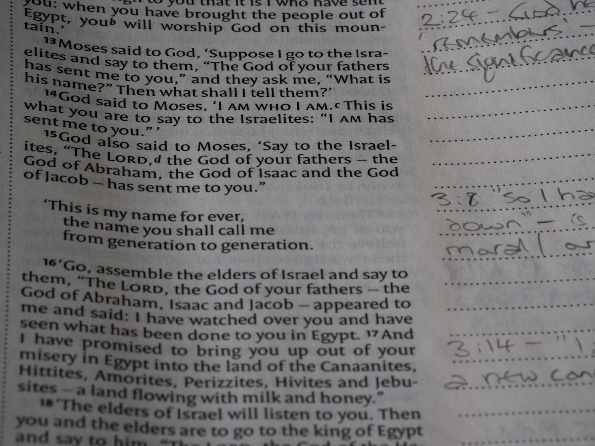 Close-up of an open book with handwritten notes.