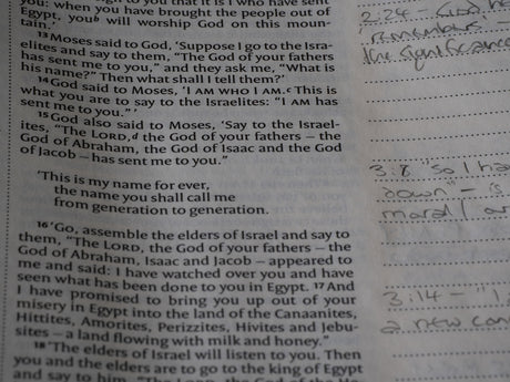 Close-up of an open book with handwritten notes.